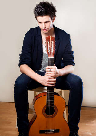 Young man playing guitarの写真素材