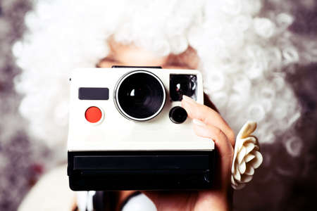 Girl holding camera.の写真素材