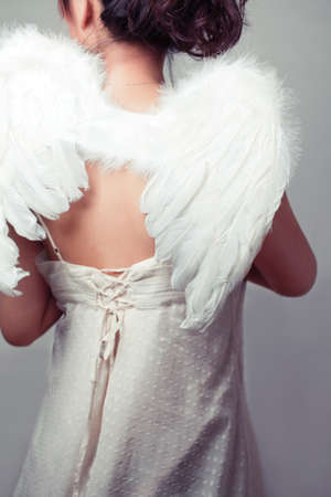 Girl wearing a white top with wings.の写真素材