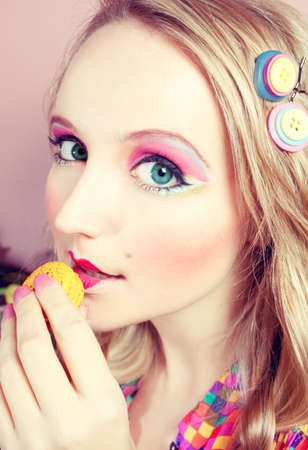A young woman loves her sweet macaron.の写真素材