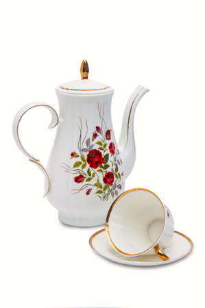 Coffee pot and cup with saucer spoon isolated on whiteの写真素材