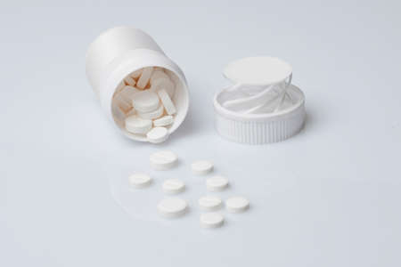 Pills spilling from a bottleの写真素材