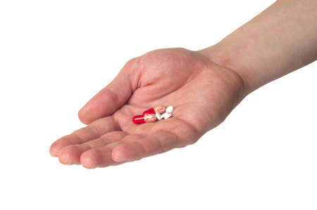 Hand holding pills, isolated on white backgroundの写真素材