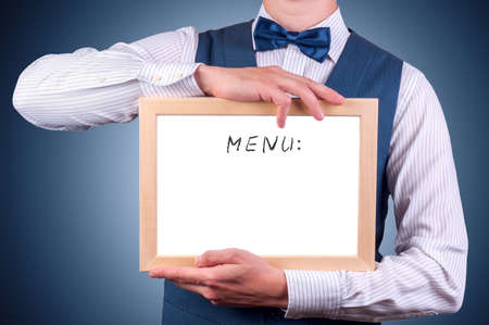 a man with a sign in his hands with the word menuの写真素材