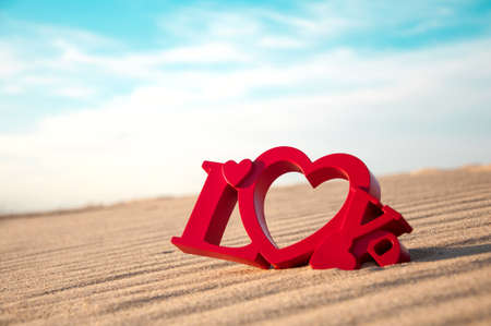 The word love and the sand in the backgroundの写真素材