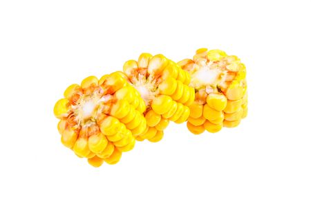 Ripe corn on the cob divided into pieces on a white backgroundの写真素材