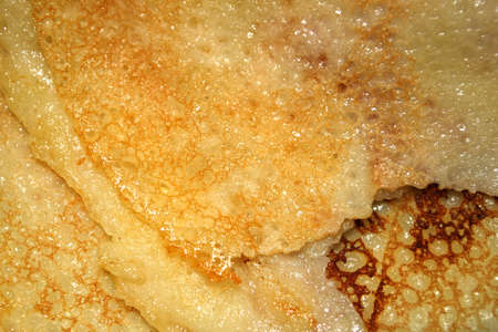 Closeup of a cooked torn pancakeの写真素材