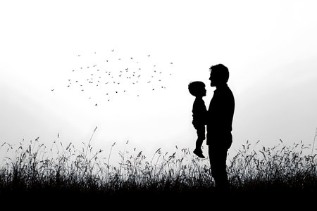 silhouette of a father holding his son in a field, watching a flock of birds fly away into the sky black and white image evokes peaceful connectionの素材