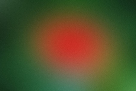 Showing soft red gradient on dark green blurred background. High resolution image suitable...の写真素材