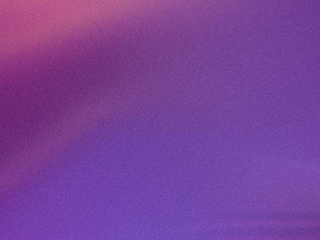 A vibrant sunset over a tranquil ocean with a gradient of purple and pink hues