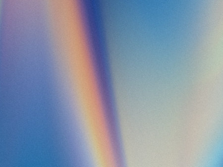 This image captures a delicate and vivid rainbow stretching across a textured, gradient sky. The...