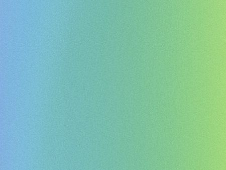 This image showcases a smooth gradient background transitioning from a deep blue hue at the top left corner to a bright green at the bottom right. The gradient is overlaid with a fine, speckled texture that gives the appearance of a soft, grainy noise, adding depth and visual interest without obscuring the color shift. The overall effect is tranquil and could evoke a sense of calm or natural elements like water and foliage blending seamlessly together.の写真素材