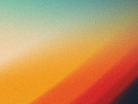 This image displays a smooth gradient transition of colors from green and blue at the top to warm hues of yellow, orange, and red towards the bottom. The background features a subtle, textured pattern that adds depth and a soft, painterly feel to the composition, giving it an abstract and artistic appearance.の写真素材