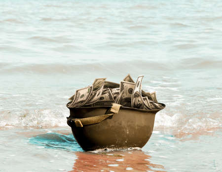 Economy and war relation concept, 3d illustration. Dollar and money wars. Dollar on Helmet. Helmet hits the beach. Photo manipulation.の写真素材
