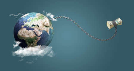 The world where money takes prisoner. The world is a prisoner of the dollar. Photo manipulation. Stone ballの写真素材