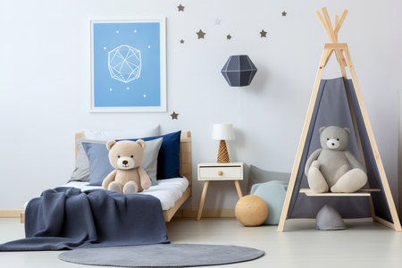A childâs bedroom with a blue and white color scheme, a bed, a nightstand, a lamp, a teepee, and two teddy bears. The walls are decorated with a framed picture and star decals.の素材
