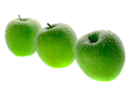 Fresh green apples isolated on whiteの写真素材