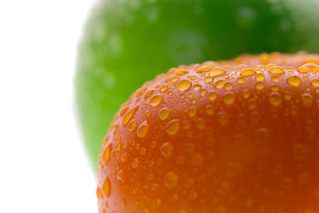 Green apple and red tomato on white backgroundの写真素材