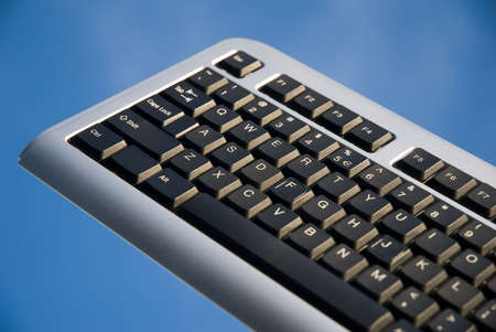 Computer keyboard on blue background