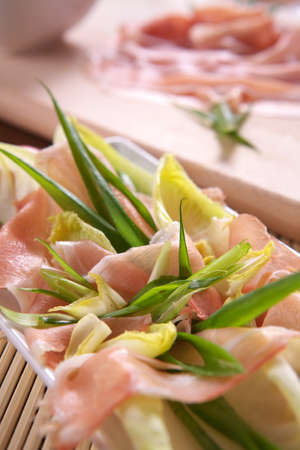 Fresh salad with ham, onion and basilの写真素材