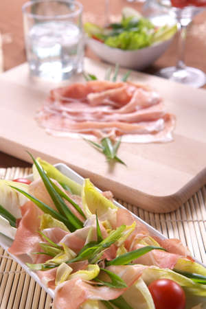 Fresh vegetable salad with ham, onion and basilの写真素材