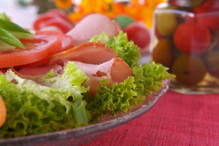 Fresh salad with onion, tomato, ham and basilの写真素材