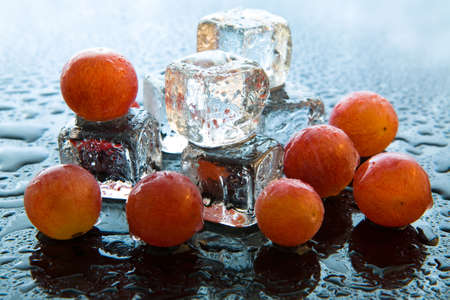 Grapes with ice cubes on reflective backgroundの写真素材