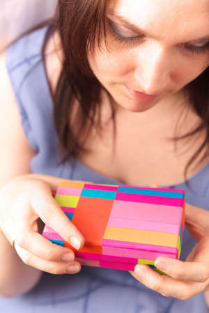 Beautiful young woman with gift box
