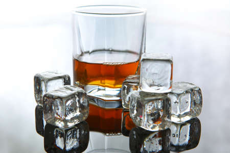 Whiskey in glass with ice cubesの写真素材