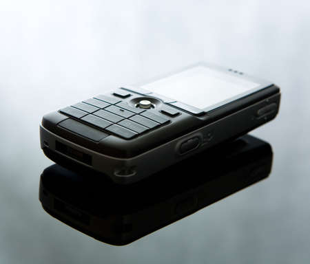 Cell phone on reflective background