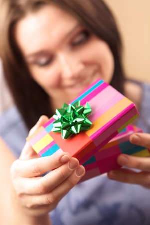 Beautiful young woman with gift box