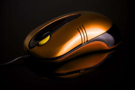 Computer mouse on reflective backgroundの写真素材