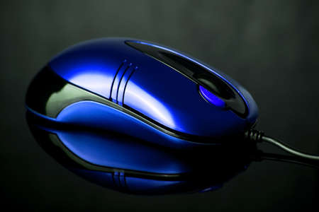 Computer mouse on reflective backgroundの写真素材