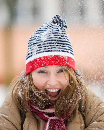 Beautiful woman playing with snowの写真素材