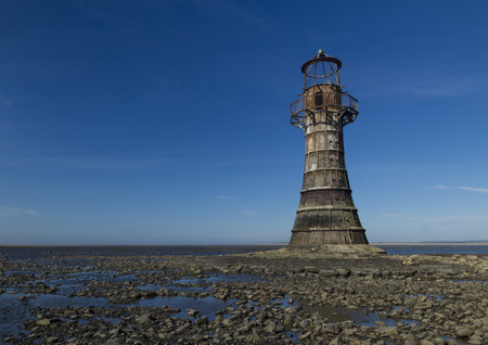 Whiteford Lighthouse is the only wave swept cast iron lighthouse in Britain. See here at low tide. Whiteford Point, Whiteford Sands, Gower Peninsular, South Wales, United Kingdom, Europe.の写真素材