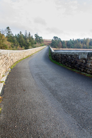Reservoir with road over dam. Venford Reservoir, Dartmoor National Park, Devon, England, United Kingdom.の写真素材