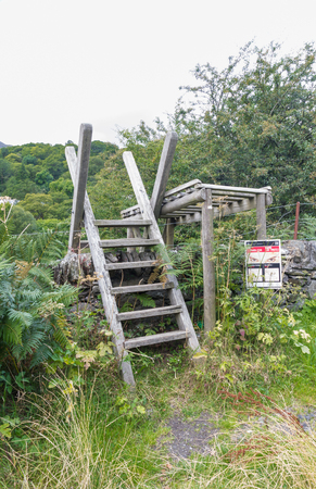 Typical ladder stile over dry stone wall Snowdonia National Park Gwynedd Wales United kingdom.の写真素材