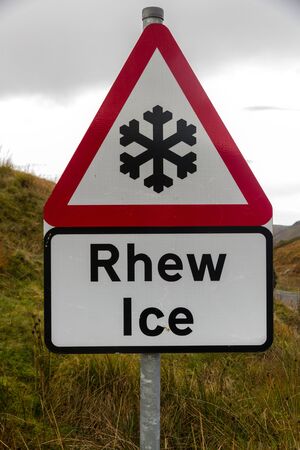 Snowflake triangular warning sign, Wales, warning of Ice, Welsh bilingual Rhew, United Kingdomの写真素材
