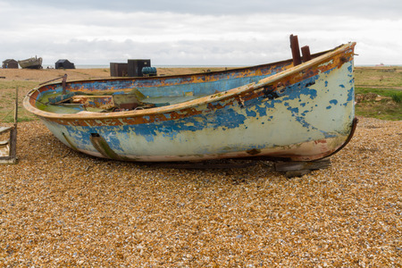 Old wooden boat with flaking paint. Dungeness Beach, Kent, England, United Kingdom.の写真素材