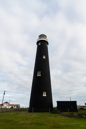 Black lighthouse. Dungeness Old Lighthouse, Kent, England, United Kingdom.の写真素材