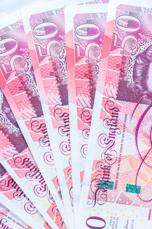 A fan made of fifty pound sterling notes money.の写真素材