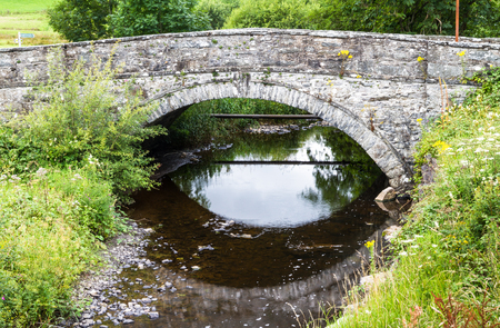Old stone back bridge, with over Afon Merddwr river. Pentrefoelas, Conwy County, Wales, United...