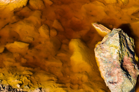 Orange, Stained water on derelict copper mining area of Parys Mountain. Amlwch, Anglesey, Wales, United Kingdomの写真素材