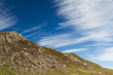 Cirrus cloud above mountain and in blue sky.の写真素材