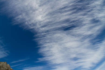 Cirrus cloud above mountain and in blue sky.の写真素材