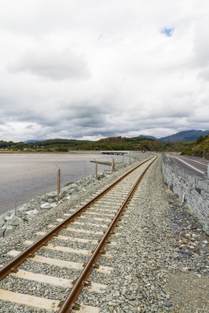 The Pont Briwet bridge carries rail and road over the River Dwyryd, near Penrhyndeudraeth. Gwynedd, Snowdonia, Wales, United Kingdom.の写真素材