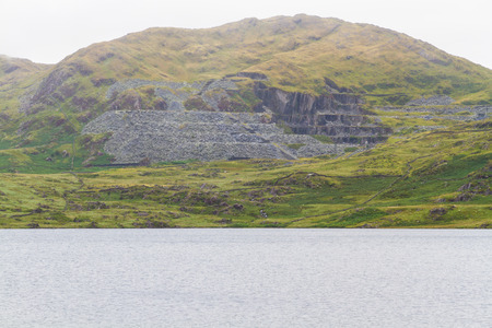 Cwmystradllyn Slate Quarry with reservoir in foreground.の写真素材