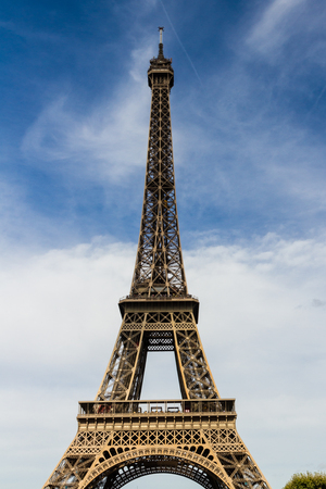 Eiffel Tower against blue sky and clouds.の写真素材