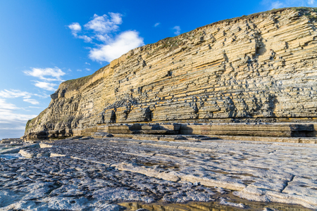 Carboniferous limestone cliffs of Southerndown Beach or Dunraven Bay, afternoon light. Used as Bad Wolf Bay in Doctor Who. South Wales, UK.の写真素材