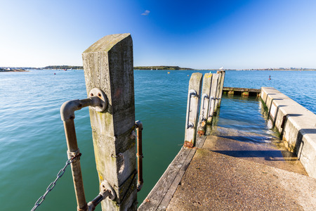 Jetty with mooring in Christchurch Harbour on a sunny day. England, United Kingdom.の写真素材
